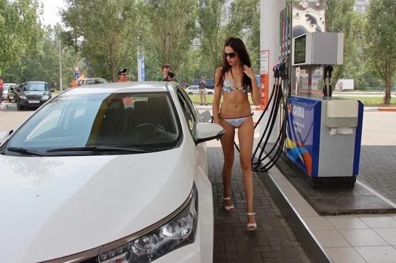 Donna in bikini in una stazione di servizio in Russia